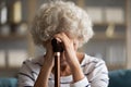 Close up image woman bowed her head holding walking stick Royalty Free Stock Photo