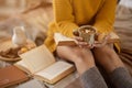 A woman in a cosy sweater and winter socks sitting on a bed with a cup of hot cocoa in her hands Royalty Free Stock Photo