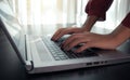 Close up image of woman hands typing on laptop computer keyboard , surfing the internet or online working . business and technolo