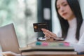 Close-up image of a woman making an online purchase on a computer using a mockup credit card. Selective focus Royalty Free Stock Photo