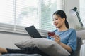 Close up image of woman making an online purchase on tablet computer with a credit card. Selective focus Royalty Free Stock Photo