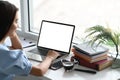 A close-up image of a woman is using a computer laptop at the white working desk. Royalty Free Stock Photo