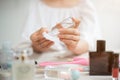 Close-up image of a woman dropping makeup remover on a cotton pad to clean her face Royalty Free Stock Photo