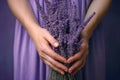 close-up image of a womans hand holding a bunch of lavender