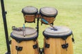 Close up image of wooden ethnic drums on green background.