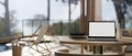 Workspace with laptop mockup on a wooden table in living room with pool access