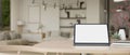 Close-up image of workspace with portable tablet mockup in minimal white living room