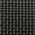 Close-up image of a woven metal mesh. The mesh features an intersecting grid pattern with parallel Royalty Free Stock Photo