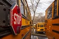 A close up image of yellow American school bus with selective focus on the stop sign on the side Royalty Free Stock Photo