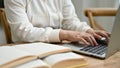 Close-up image of a young Asian female college student using her laptop at a coffee shop Royalty Free Stock Photo