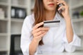 Close-up image of a young Asian female contacts a credit card call-center service Royalty Free Stock Photo