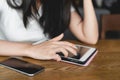 Young asian woman in casual using digital tablet and smartphone