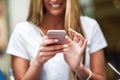 Close-up image of young blonde girl texting with smartphone Royalty Free Stock Photo