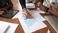 Close up image young businessman editing paper documents.