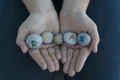 Close up image of young female hands hold gray round stones with letters on them and inscription relax. Creative ideas concept. Royalty Free Stock Photo