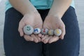 close up image of young female hands hold gray round stones with letters on them and inscription smile. Royalty Free Stock Photo