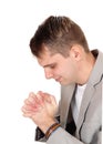 Young man praying with hands folded Royalty Free Stock Photo