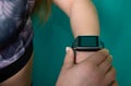 Close up image of young woman checking the time on smart watch device Royalty Free Stock Photo