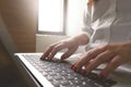 Close-up image of young woman hands typing and writing massages on laptop,working on cafe or home Royalty Free Stock Photo