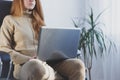 Close-up image of young woman using laptop working at home office, hipster girl freelancer Royalty Free Stock Photo