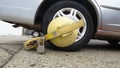 Close up of impounded car tire with yellow boot lock in New York City