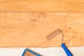 Close-up, impregnation of the wooden floor with a dark varnish roller, manually, there is a place for inscription Royalty Free Stock Photo