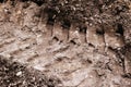 Close-up of the imprint of a tank track or construction equipment on the ground