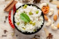 Close-up of Indian Basmati steamed Rice or matar Pea pulao or Pulav garnished with fresh green mint leaf in a black bowl Royalty Free Stock Photo