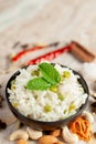 Close-up of Indian Basmati steamed Rice or matar Pea pulao or Pulav garnished with fresh green mint leaf in a black bowl Royalty Free Stock Photo