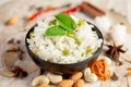 Close-up of Indian Basmati steamed Rice or matar Pea pulao or Pulav garnished with fresh green mint leaf in a black bowl Royalty Free Stock Photo