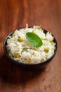 Close-up of Indian Basmati steamed Rice or matar Pea pulao or Pulav garnished with fresh green mint leaf in a black bowl Royalty Free Stock Photo