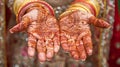 Close-up of an Indian bride& x27;s hands with intricate henna design and traditional bangles