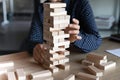 Close up Indian businesswoman building tower from wooden blocks