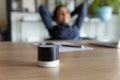 Close up Indian businesswoman listening to music on portable speaker