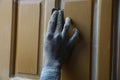 Close up of indian carpenter dirty hand doing wood finishing of home furniture using sandpaper,