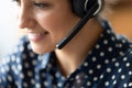 Closeup indian woman helpline employee wear headset talk to client