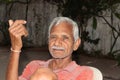 An Indian farmer and old man sitting in the courtyard of the house with smiling and happy face in the evening Royalty Free Stock Photo