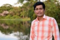 Close up of Indian man against scenic view of the lake in peacef