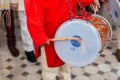 Close-up Indian musician guy drumming Dhol and wearing red Bandhgala at Indian wedding ceremony in Bangkok, Thailand