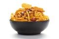 Close-Up of Indian spicy snacks Namkeen - All in one in a black Ceramic bowl, made with fried peanut, corn flakes, sweet pea, Royalty Free Stock Photo