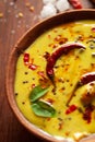 Close-up of Indian traditional kadhi or kadi pakora yogurt and gram flour and turmeric served hot in a clay bowl. Royalty Free Stock Photo