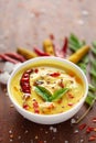 Close-up of Indian traditional kadhi or kadi pakora yogurt and gram flour and turmeric served hot in a clay bowl.