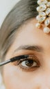 an indian female putting a mascara Royalty Free Stock Photo