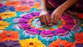 Close up of indian woman hand embroidering colorful flowers