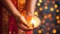 Close up of Indian woman hands holding sparkler with bokeh background