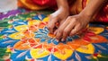 Close up of indian woman hands making indian rangoli