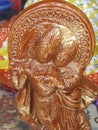 CLOSE UP OF AN INDIAN  WOODEN ART OF A TINY STATUE OF LORD KRISHNA Royalty Free Stock Photo