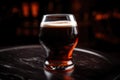 close-up of individual glass of draught beer with foamy head and rich color