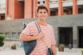 Close up individual portrait of a handsome student young man standing at university campus. Happy teenage male smiling Royalty Free Stock Photo