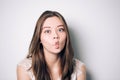 Close up indoor fashion lifestyle portrait of pretty young brunette girl, long hairs, cute face, making crazy funny grimace. funny Royalty Free Stock Photo